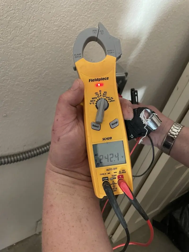 Voltage testing with clamp meter during Ceiling Fan Installation in Salida del Sol Estates